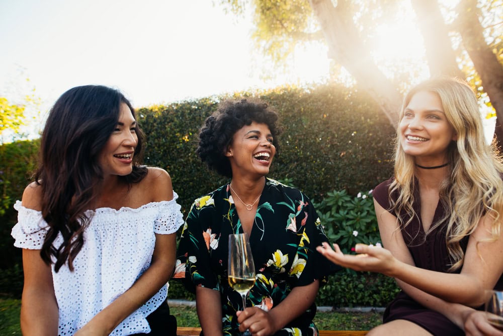 Happy,Young,Female,Friends,Hanging,Out,And,Talking,At,Outdoors