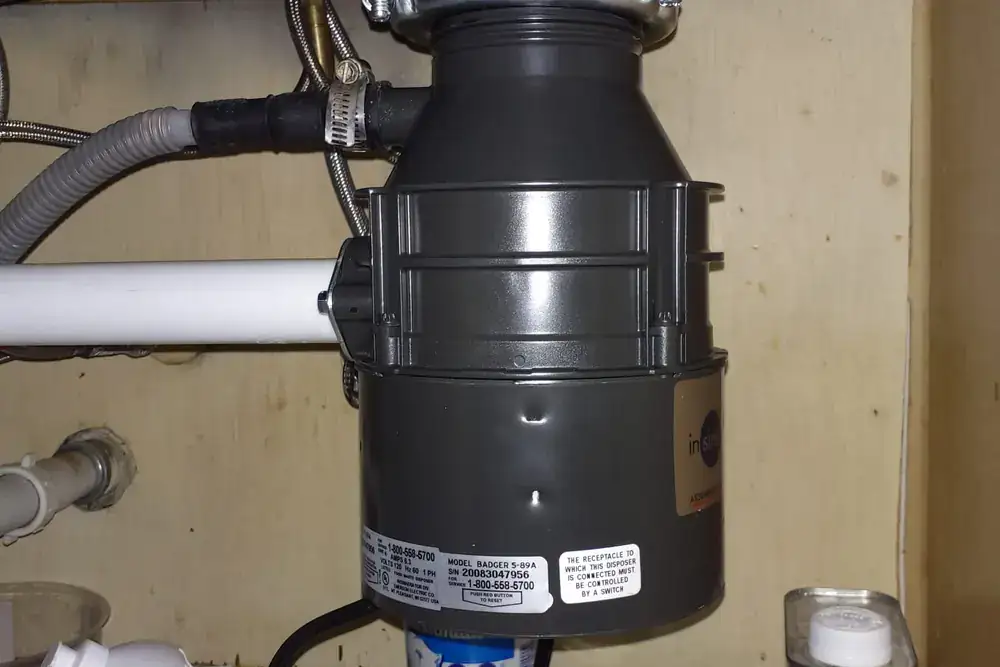 Garbage disposal replacement under a residential kitchen sink in San Antonio
