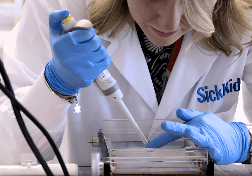 A SickKids researcher pipettes into a gel electrophoresis plate