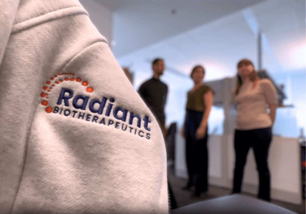Close up image of the Radiant Biotherapeutics logo embroidered on the arm of a sweater