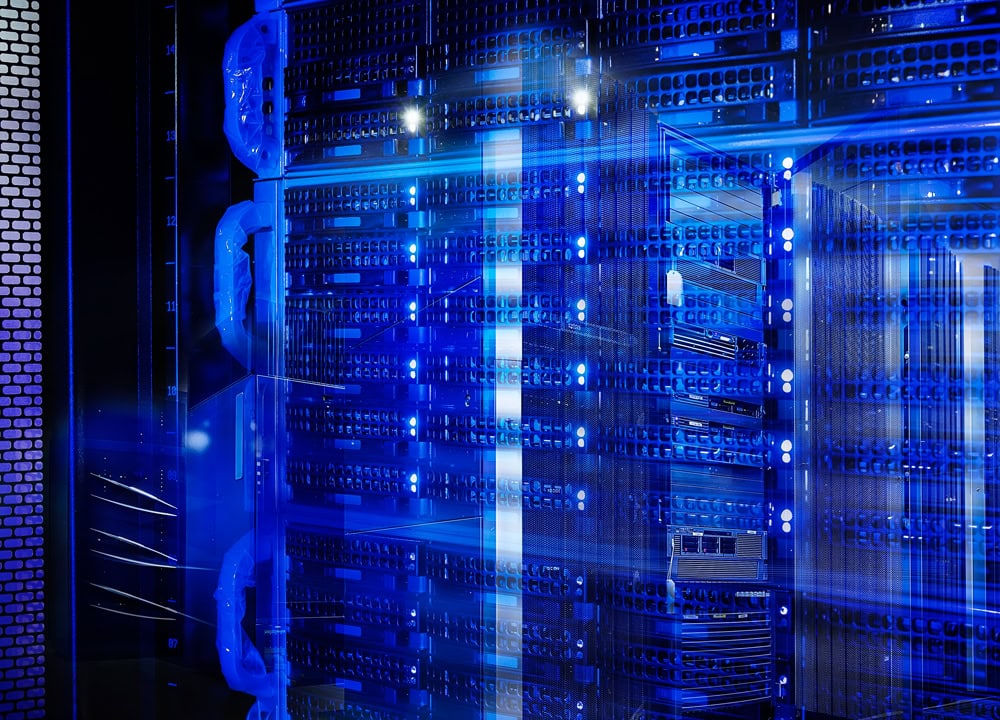 A large server room with many blue lights.