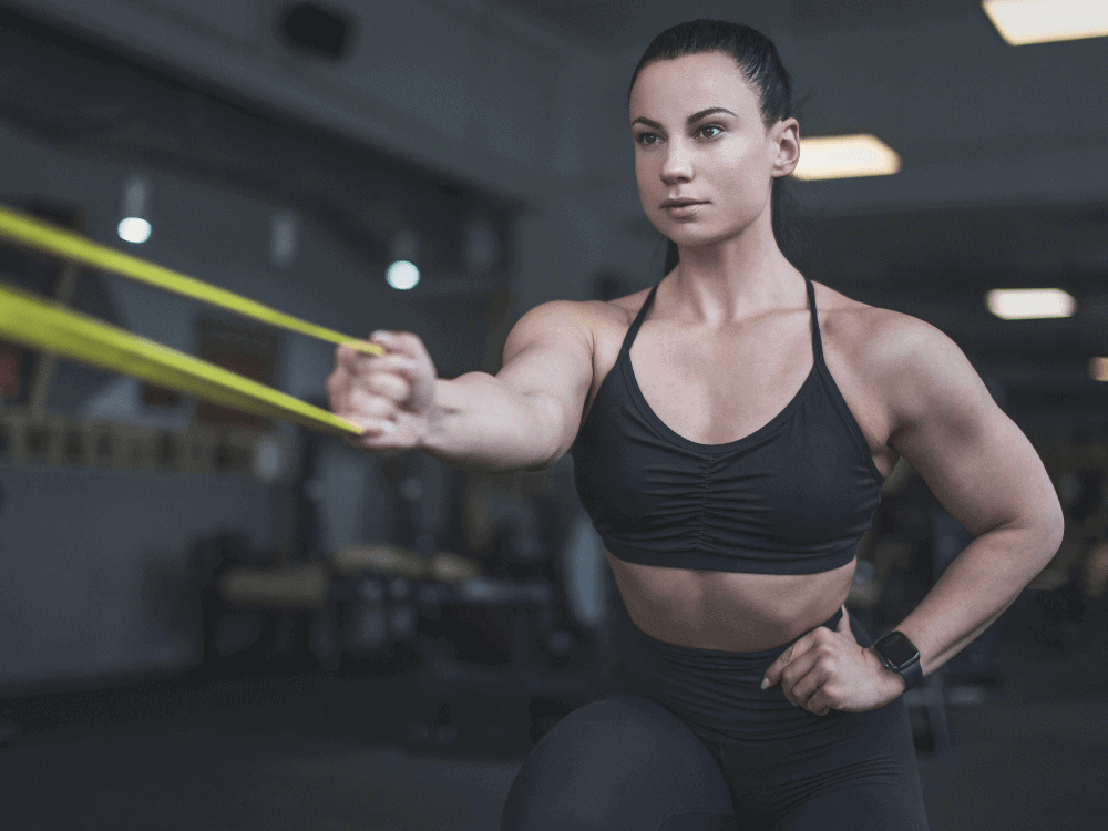 Woman performing resistance band exercise — Post-Rehab Personal Training Los Angeles at Body360 Fit