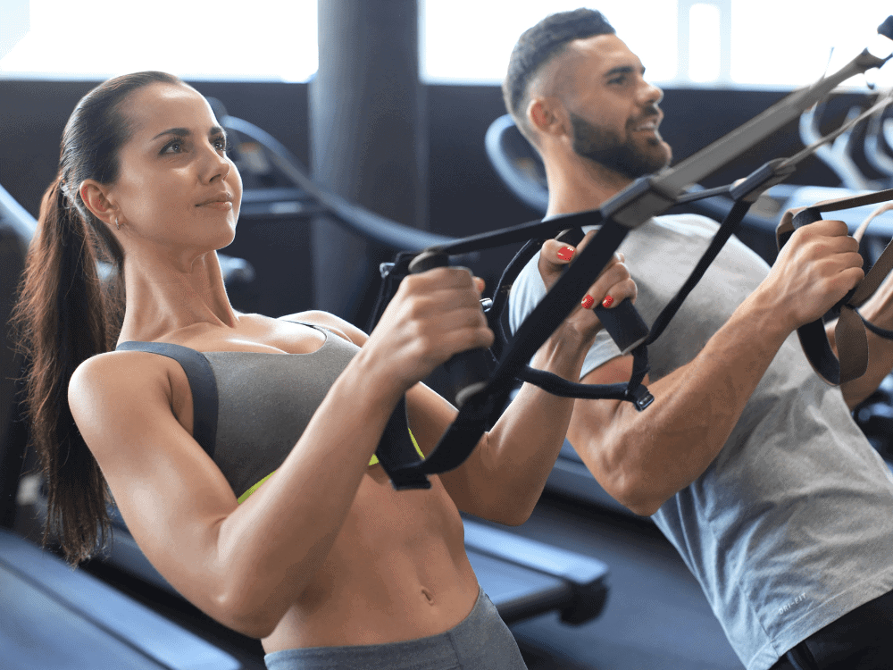 Clients performing TRX suspension rows at Body360 Fit in Los Angeles to build strength, stability, and core control.