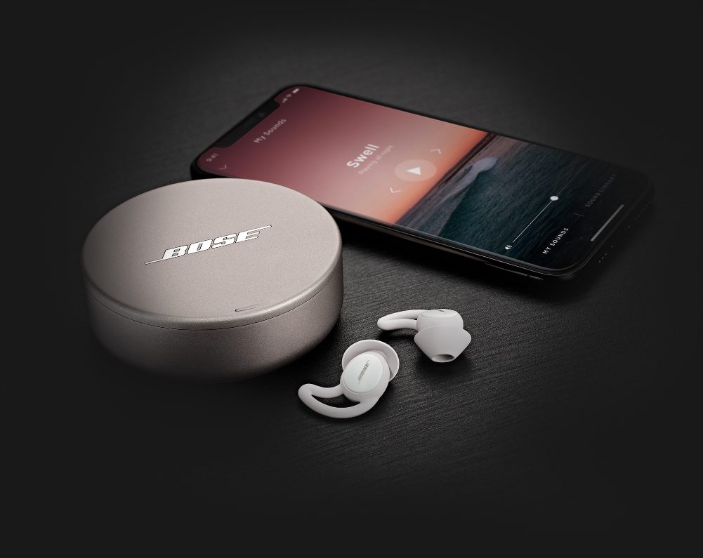 Bose Sleepbuds next to a smartphone with a sleep sound