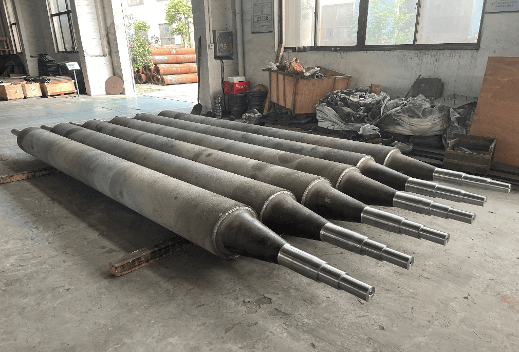 Furnace rolls with tapered ends and extended shafts arranged on the factory floor