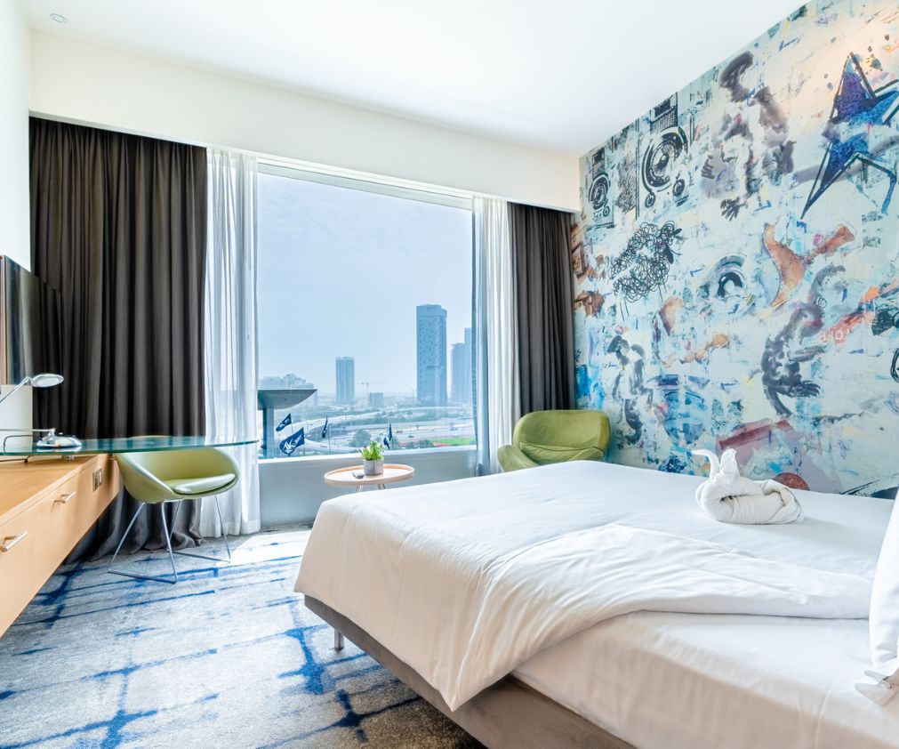 2 Modern hotel suite with contemporary furnishings and a stunning cityscape view.
