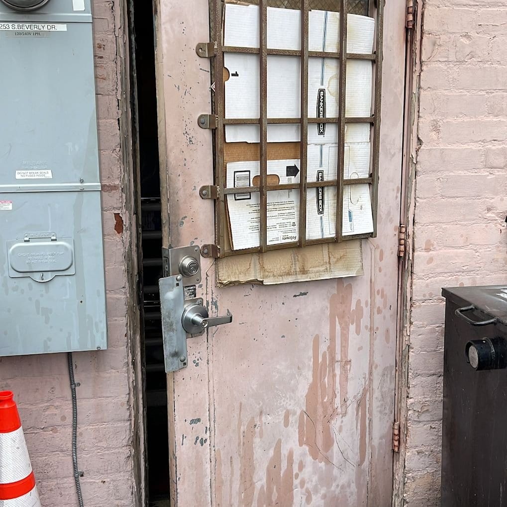 Heavy-duty lock hardware installed on a commercial rear service entrance