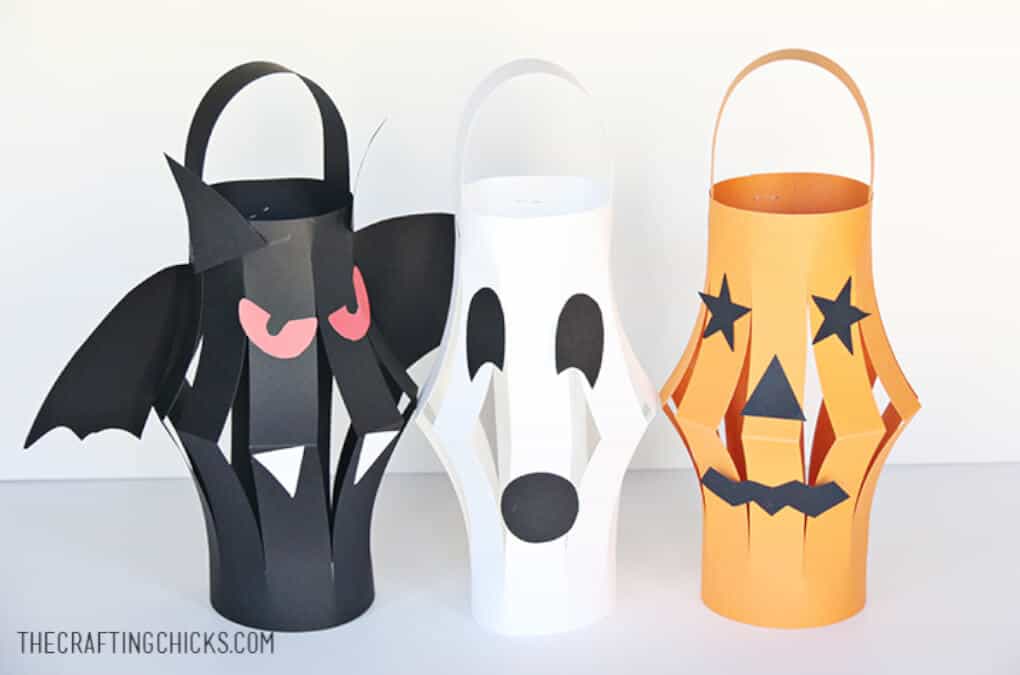 Halloween inspired paper lanterns shaped like a black bat, orange pumpkin and white ghost