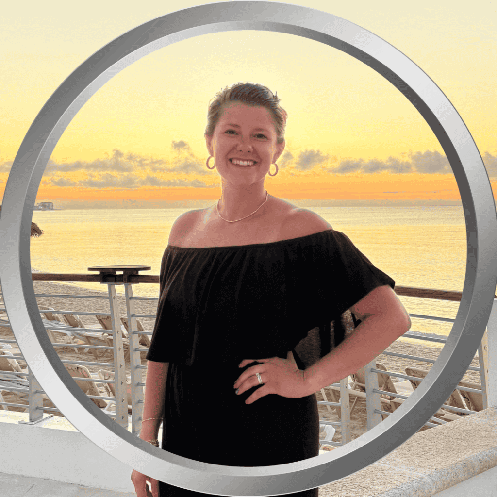 Sunset beach scene featuring ChelseaElder smiling at the camera during a vacation.