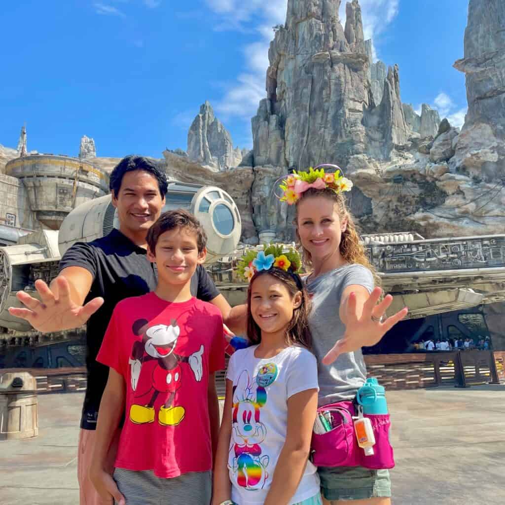 Family enjoying a trip to Star Wars galaxy's edge, with themed attractions and breathtaking scenery.