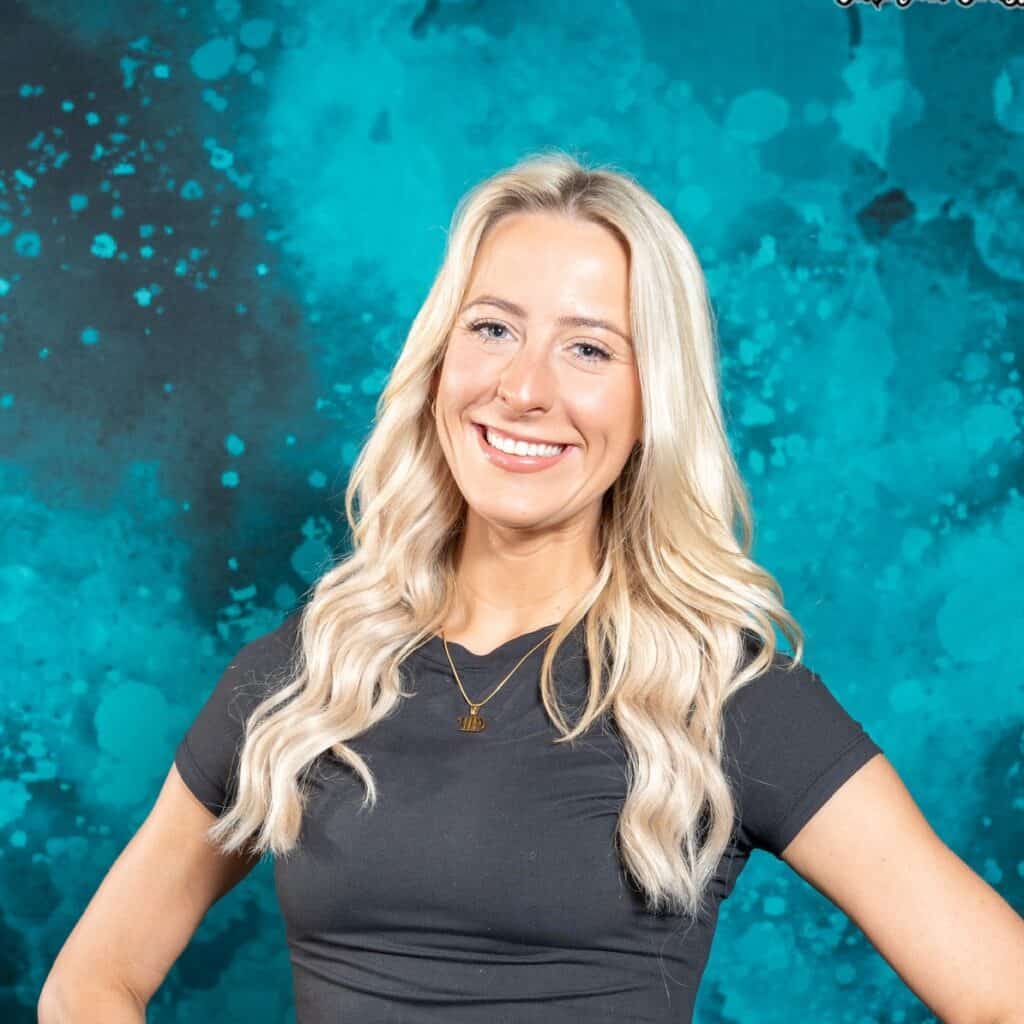 Friendly woman smiling with long blonde hair, travel agency expert for 407 and Beyond Vacation Co.