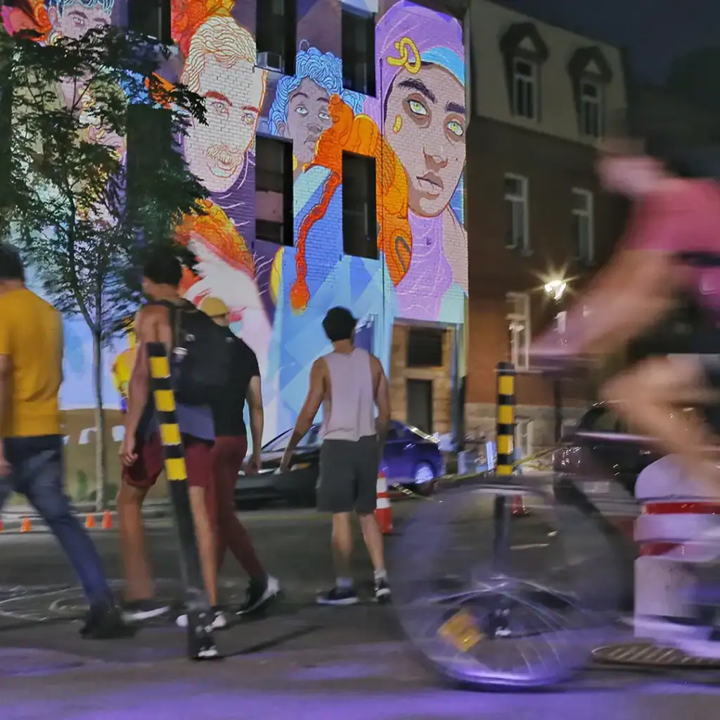 Public crowd watching street art projection mapping
