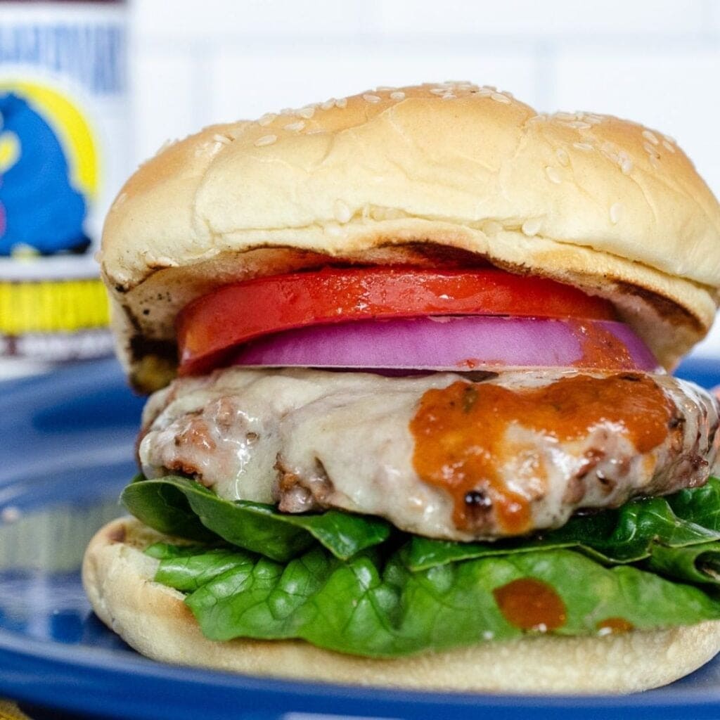 A burger slathered in Secret Aardvark Smoky Chiptole Habanero Sauce