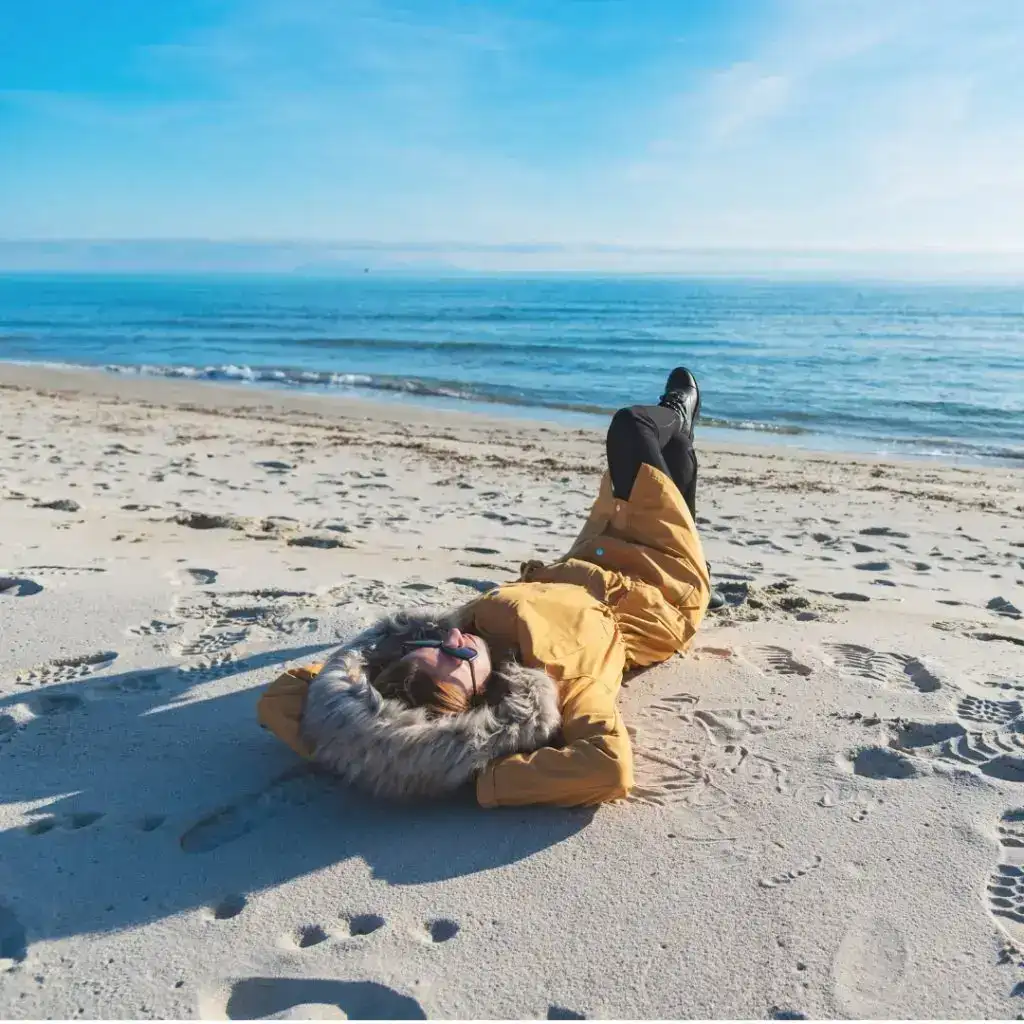 Laying on Beach with Coat on