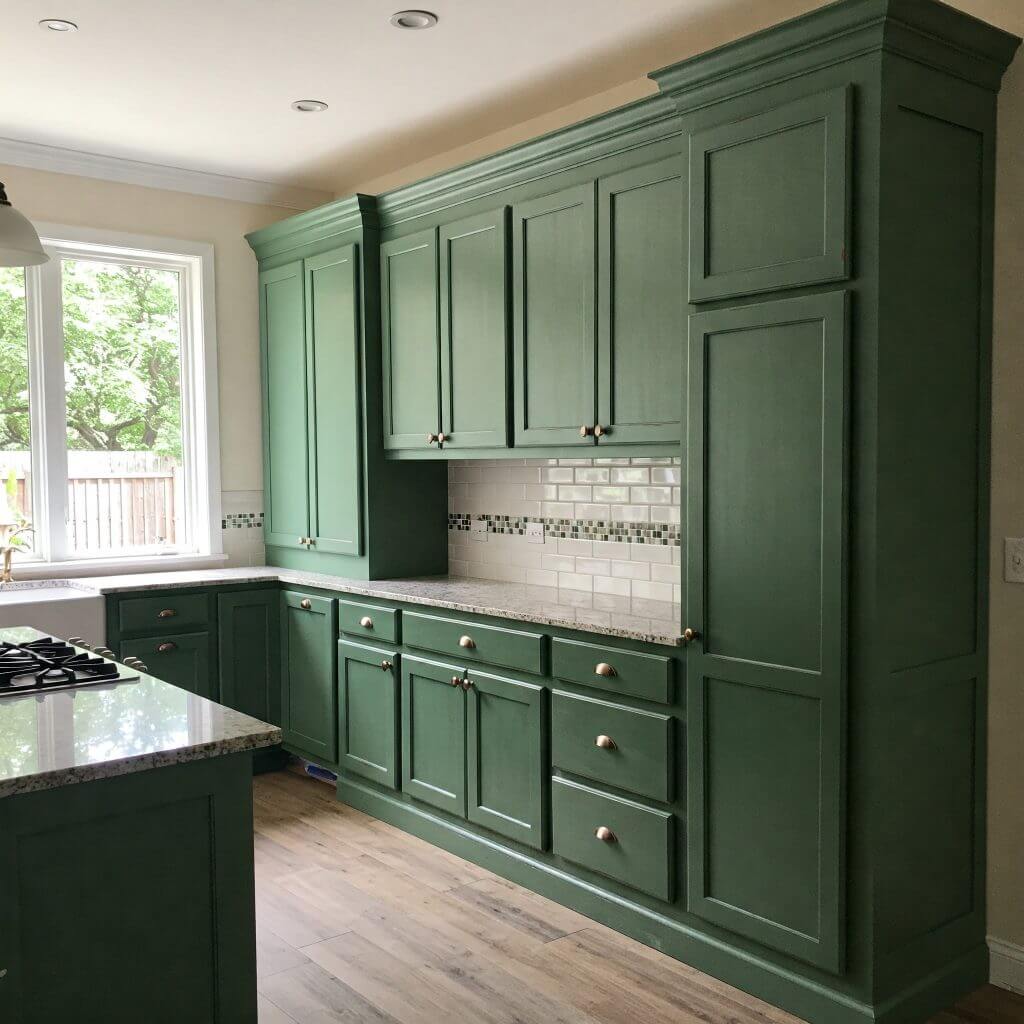 Green kitchen cabinets with modern design and countertops