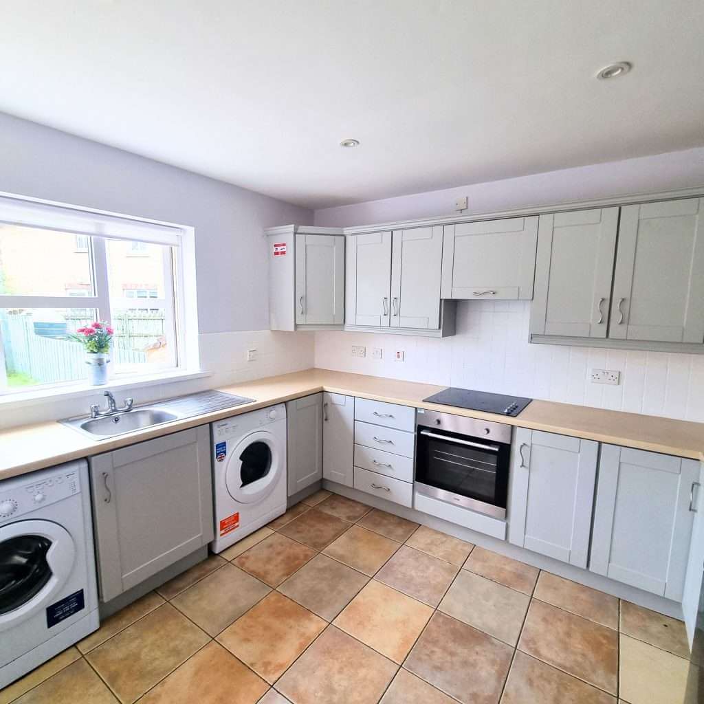 Modern kitchen with appliances and tiled floor