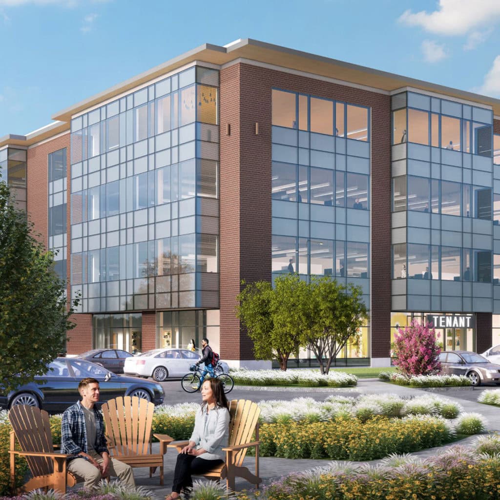 Modern office building with large windows, people sitting outside, and a cyclist passing by