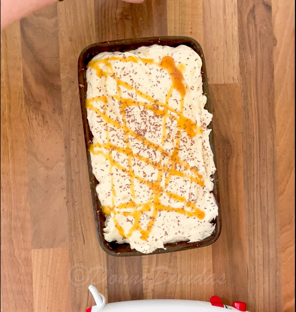 banoffee ice cream mix in loaf tin drizzled with toffee sauce and topped with grated chocolate.