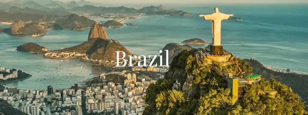 an aerial view of Rio de Janeiro, Brazil, featuring the iconic Christ the Redeemer statue on Corcovado mountain and Sugarloaf Mountain in the background.