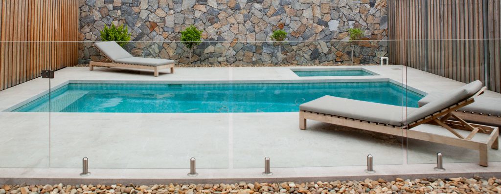 Swimming pool project feature wall with eyre limestone cladding and mosaic pool tile