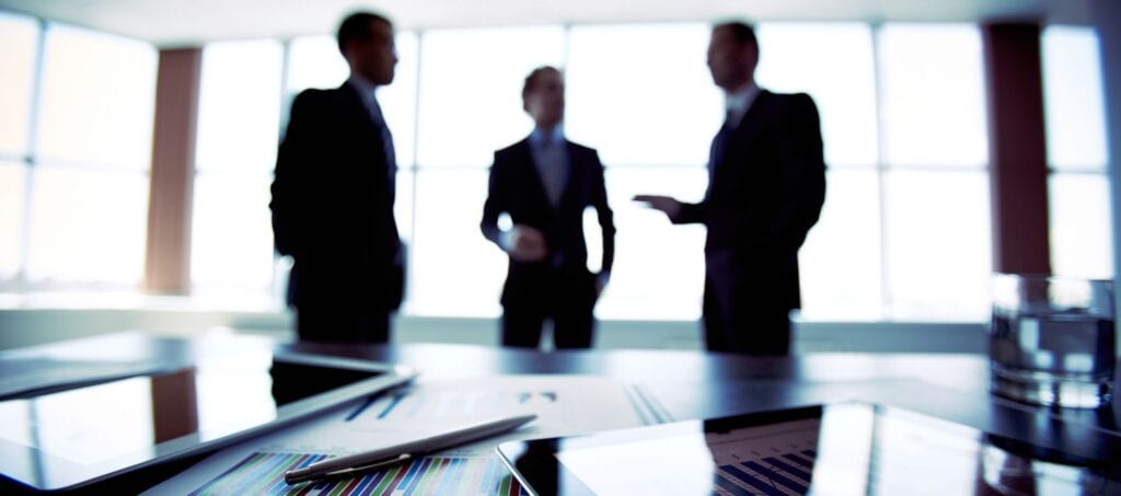 Blurred businessman working together in the office with ipads in front of the camera