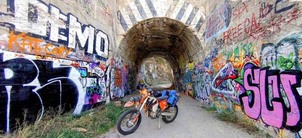 Picture of KTM motorcycle in front of the tunnel of flags