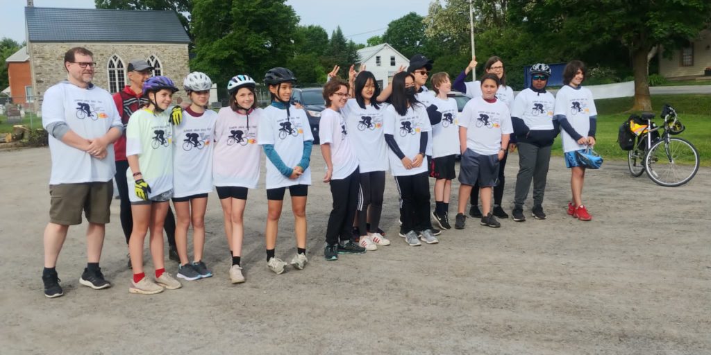 Students in a line in white shirts taking a group photo | Bishop Hamilton Montessori School in Ottawa
