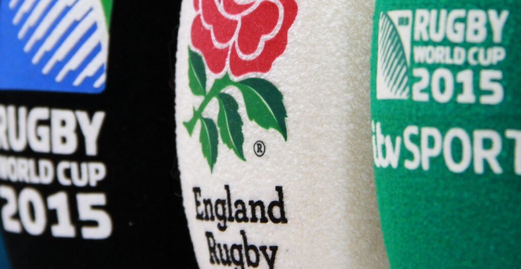 Extreme close-up of three branded foam microphone windscreens side by side, showing printed logos and textures in black, white, and green.