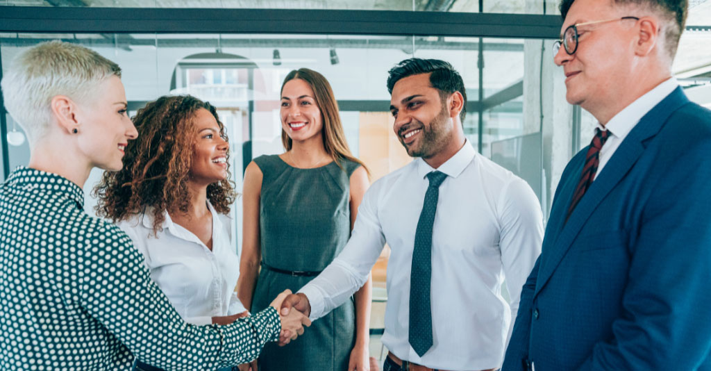 Group of business professionals shaking hands