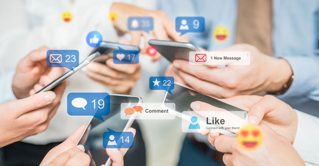 Group of people in a circle, holding their smartphones with social media icons overlayed.