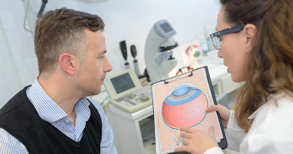 A man looking at an image of an eye