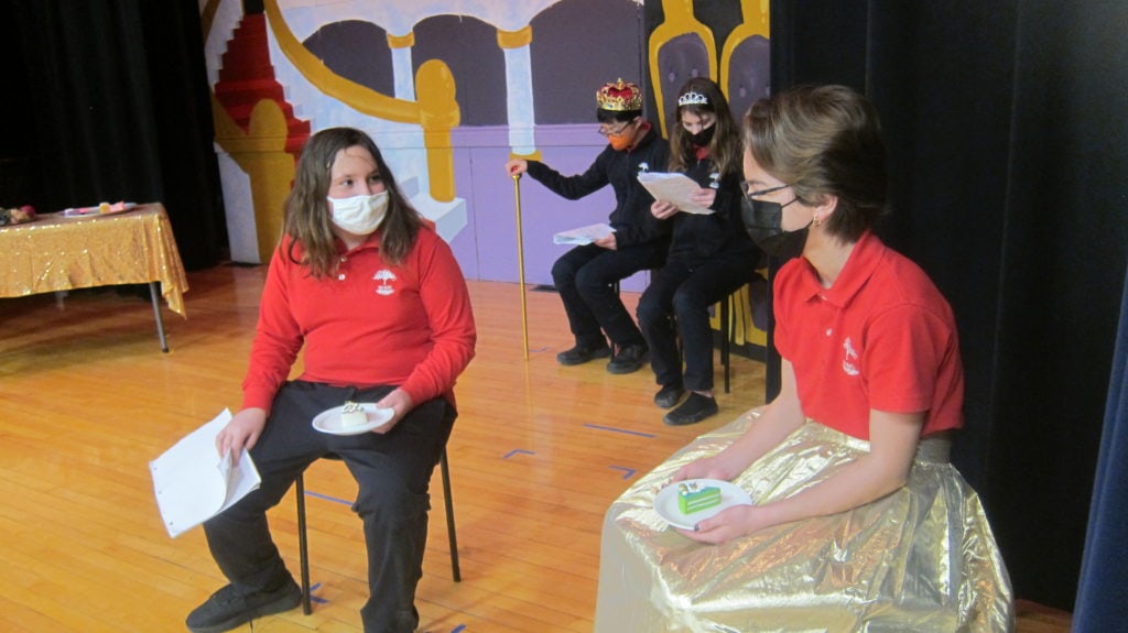 Students talking to each other on stage | Bishop Hamilton Montessori School in Ottawa