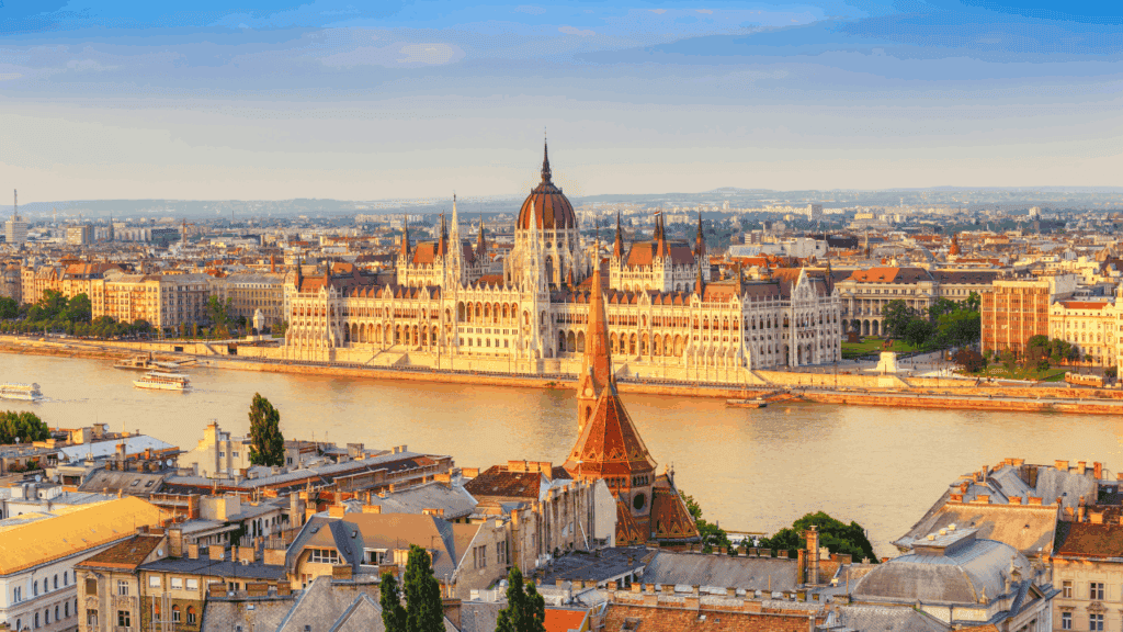 Spectacular view of Budapest Parliament Building along Danube River, Hungary, with historic architecture and cityscape.