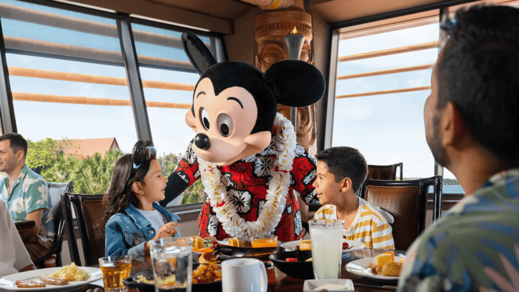 Mickey Mouse greeting children during Disney dining experience at Walt Disney World.