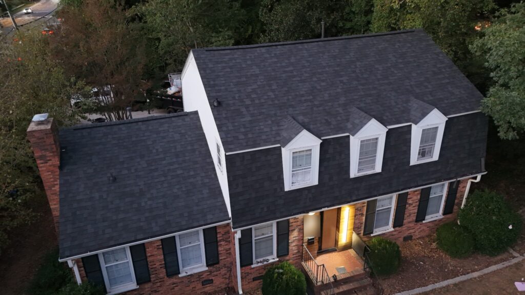Two-story brick home with three dormers on Riverbend Rd, Charlotte NC with a new Owens Corning Duration Onyx Black roof