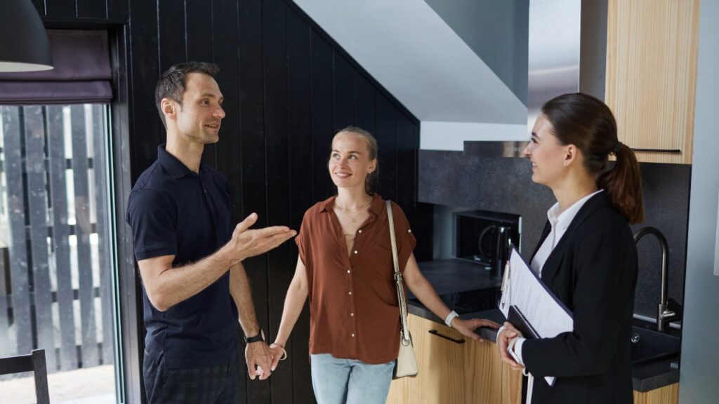 A Realtor Touring a Home for Sale to a Couple