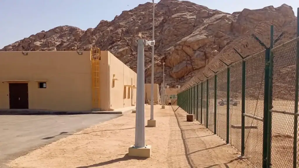 Perimeter fence in a remote desert facility achieving optimal surveillance in complex environments