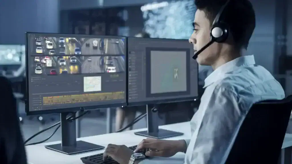 Operator monitoring multiple video feeds from VDG SENSE Video Management System on computer screens in a control room