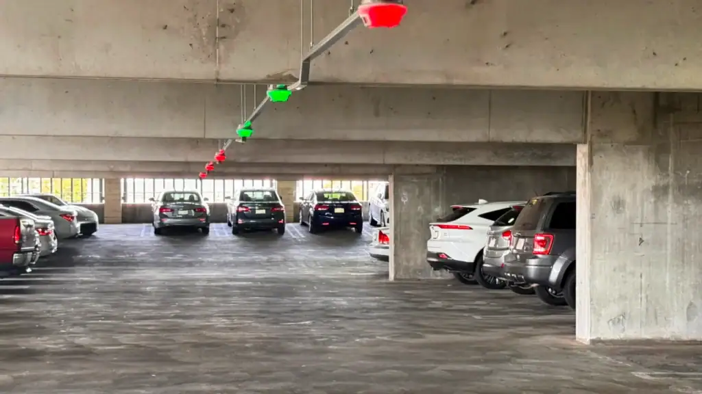 Parking garage with red and green M5 smart sensors indicating occupied and available spaces