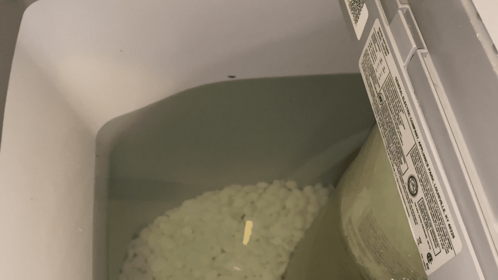 How much water is discharged from a water softener during regeneration?
