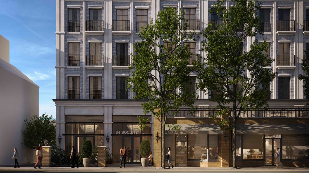 Modern mixed-use building with retail space on the ground floor and residential apartments above.