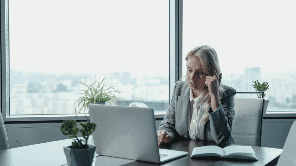 signs of a toxic workplace woman sitting at a desk looking at her computer