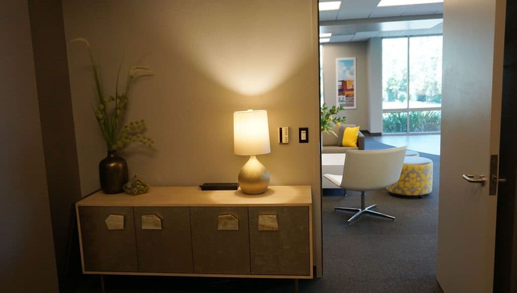 Private room. Cabinet, flowers, light, and view to main lounge area.