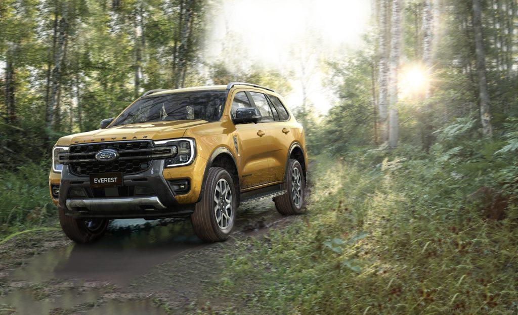 Ford Everest Wildtrak driving through muddy, wooded trail