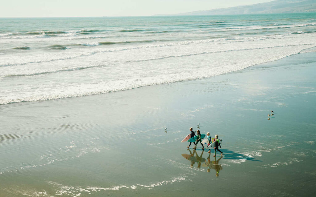 kids with surfing teacher on the beach view from above