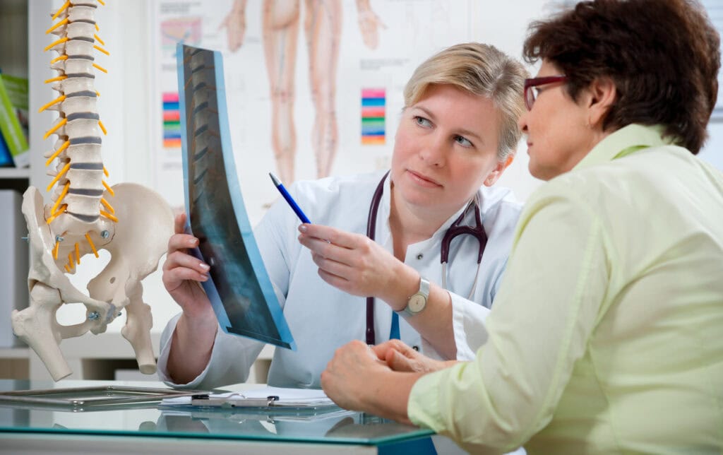 Migraine chiropractor evaluating neck alignment during consultation