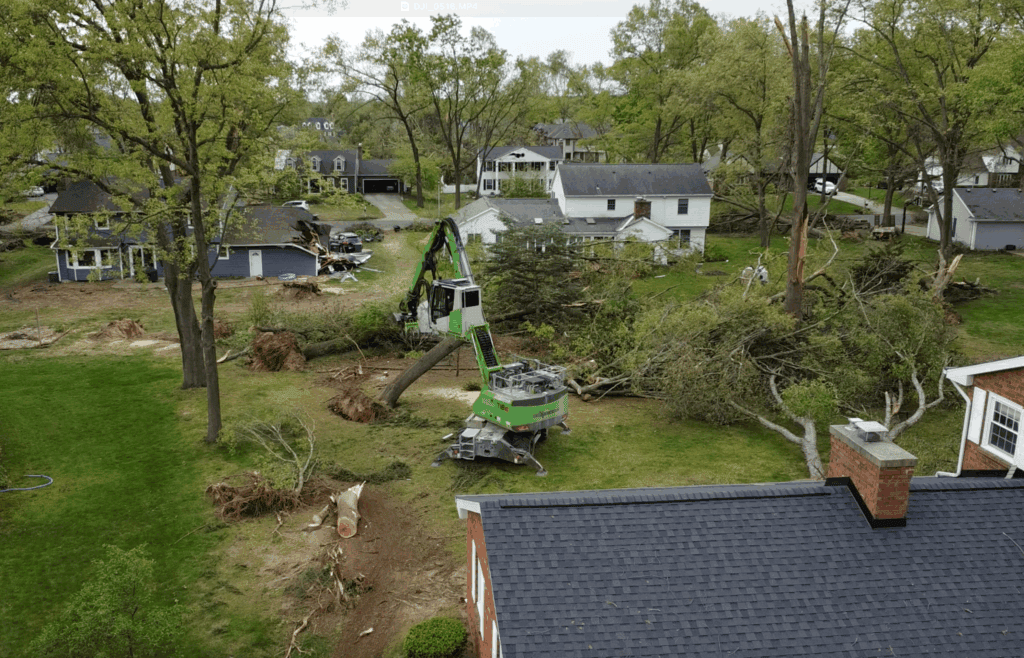 Emergency tree removal after storm damage in Fenton, MI – crew clearing large fallen trees from residential property.