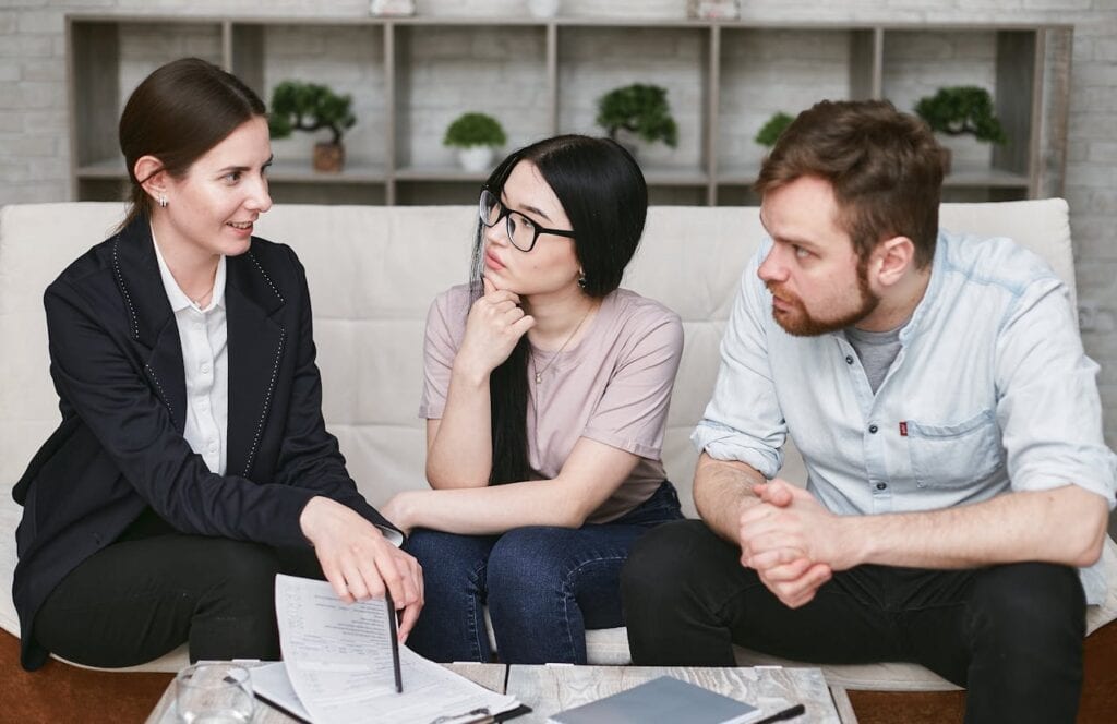 A Businesswoman Explaining Some Paperwork to a Couple