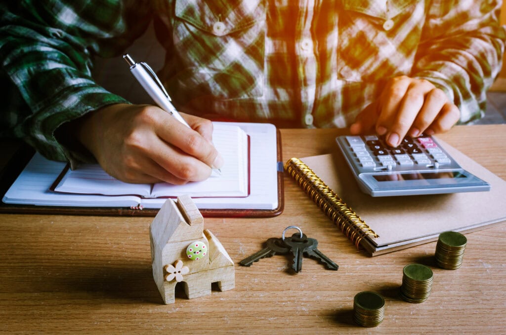 A person making calculations on how to price an investment property