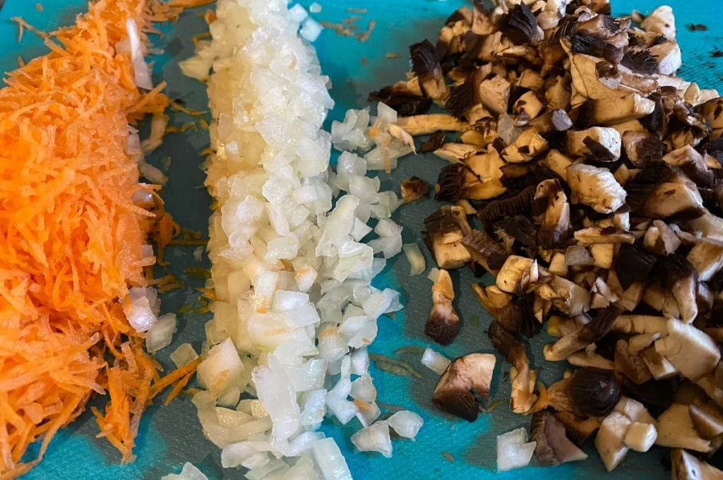 Chopped carrot, onion, and mushroom ready for vegetarian haggis recipe
